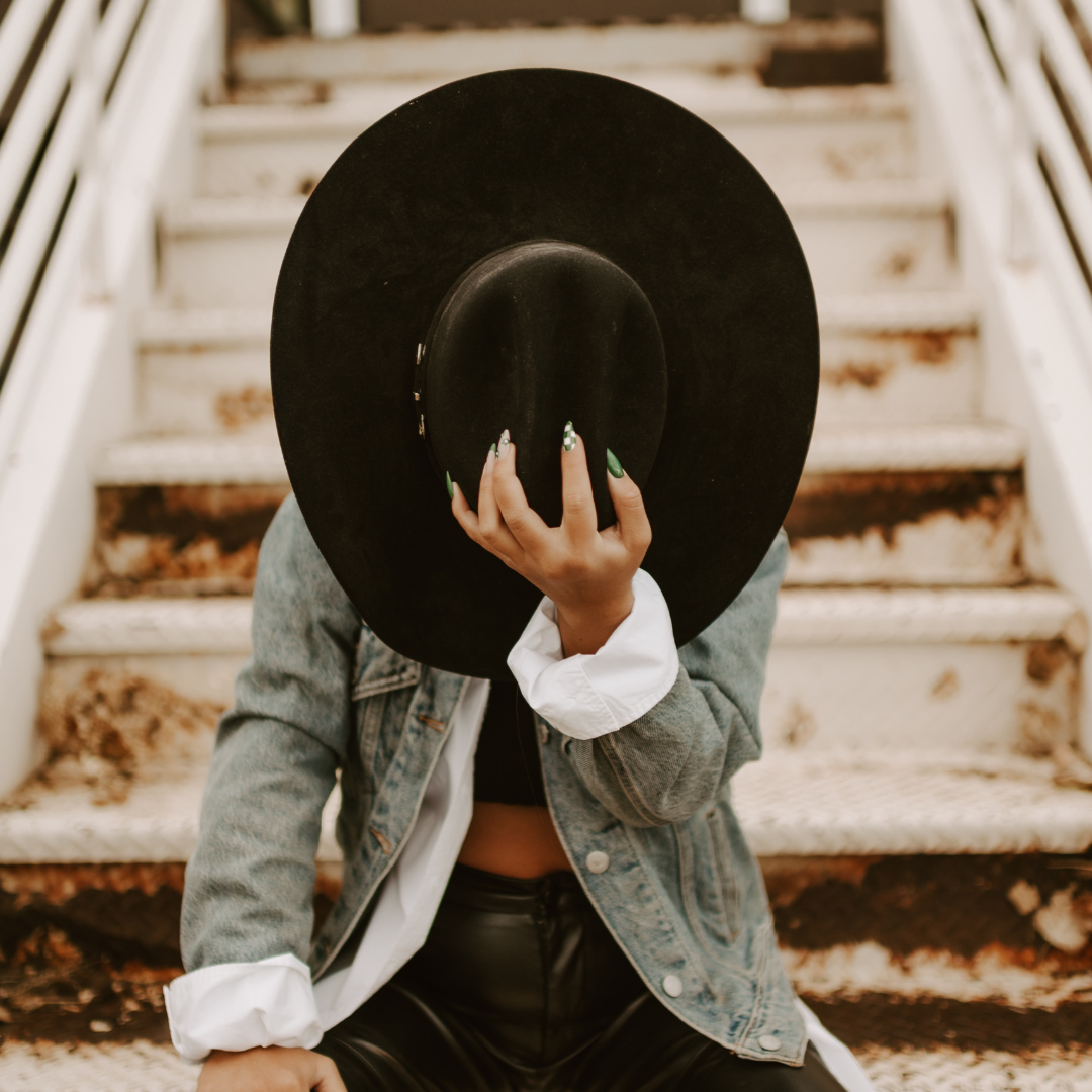 black cowgirl hat covering face