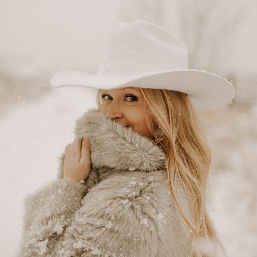 white cowboy hat and snow photoshoot